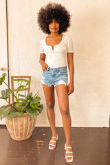 501 Mid Rise Distressed Light Wash Denim Cutoff Shorts